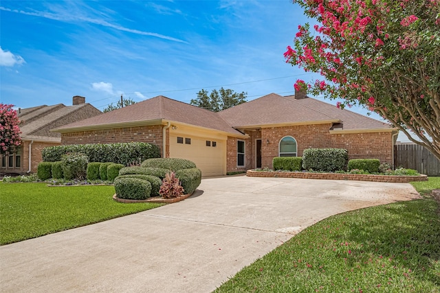 15435 Rio Plaza Dr, Houston, TX 77083 - view of front facade with brick siding, a garage, roof with shingles, and concrete driveway