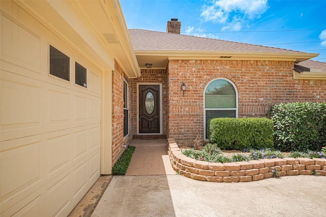 15435 Rio Plaza Dr, Houston, TX 77083 - doorway to property featuring brick siding, roof with shingles, a chimney, and an attached garage