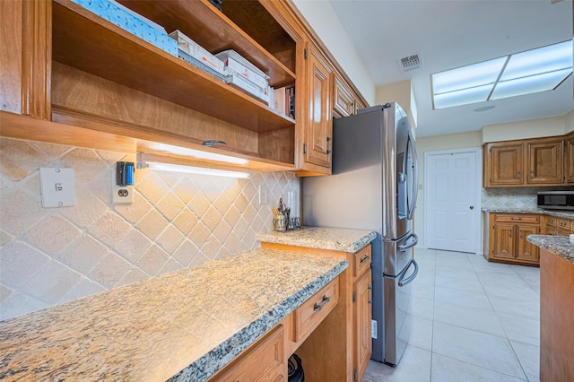 15435 Rio Plaza Dr, Houston, TX 77083 - kitchen with open shelves, stainless steel appliances, backsplash, brown cabinetry, and light tile patterned floors