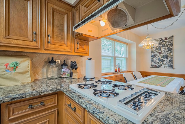15435 Rio Plaza Dr, Houston, TX 77083 - kitchen with gas cooktop, brown cabinetry, backsplash, and stone counters