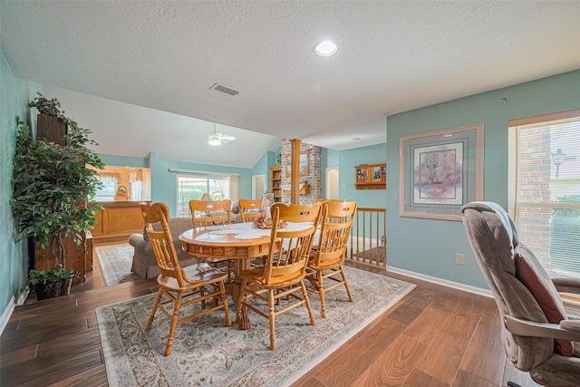 15435 Rio Plaza Dr, Houston, TX 77083 - dining area featuring a textured ceiling, wood finished floors, ornate columns, lofted ceiling, and recessed lighting