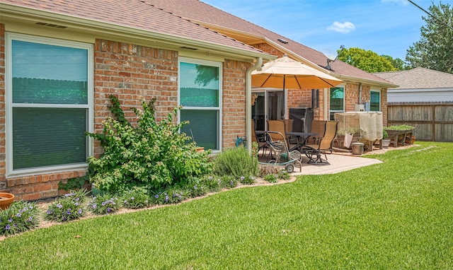 15435 Rio Plaza Dr, Houston, TX 77083 - back of property featuring brick siding, a patio area, and roof with shingles