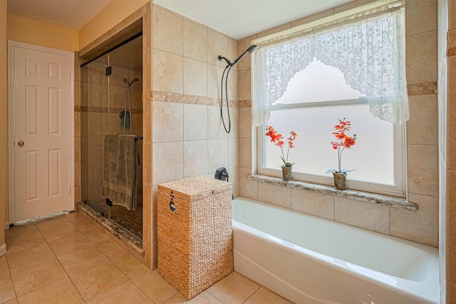 15435 Rio Plaza Dr, Houston, TX 77083 - bathroom with tile patterned flooring, a garden tub, plenty of natural light, and a shower stall