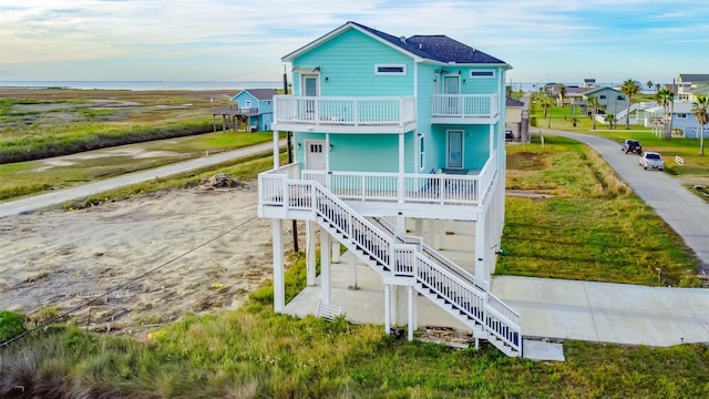 4018 6th St, Galveston, TX 77554 - back of property with a balcony, covered porch, and stairway