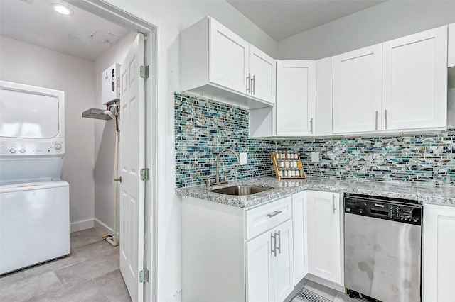 4018 6th St, Galveston, TX 77554 - kitchen featuring dishwasher, estacked washer and dryer, white cabinets, and backsplash