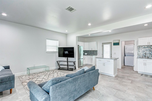 4018 6th St, Galveston, TX 77554 - living room with estacked washer and dryer, healthy amount of natural light, and recessed lighting