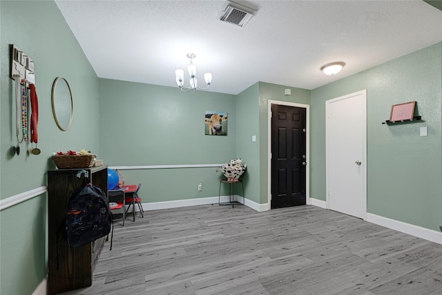 3606 Darling Ave, Pasadena, TX 77503 - entryway featuring wood finished floors, a chandelier, and a textured ceiling