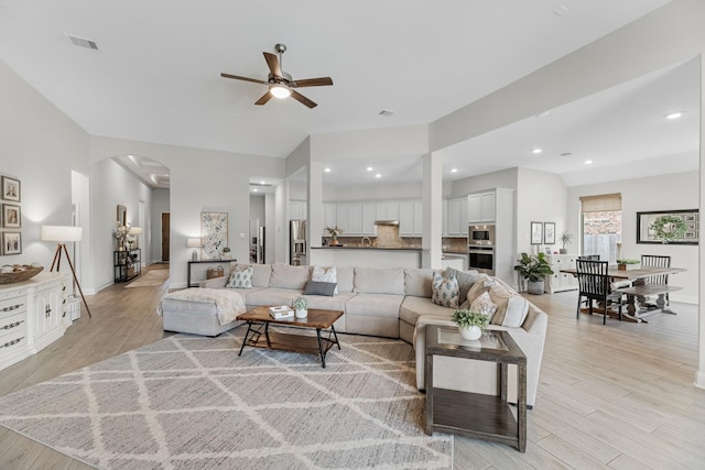 15519 Ponderosa Bend Dr, Cypress, TX 77429 - living area with ceiling fan, arched walkways, light wood-style flooring, and recessed lighting