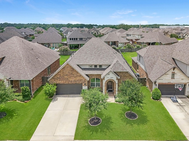 15519 Ponderosa Bend Dr, Cypress, TX 77429 - view of front facade with driveway, brick siding, a residential view, an attached garage, and a front yard