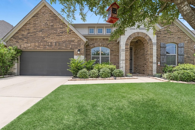 15519 Ponderosa Bend Dr, Cypress, TX 77429 - view of front of home featuring a front yard, concrete driveway, a garage, and brick siding