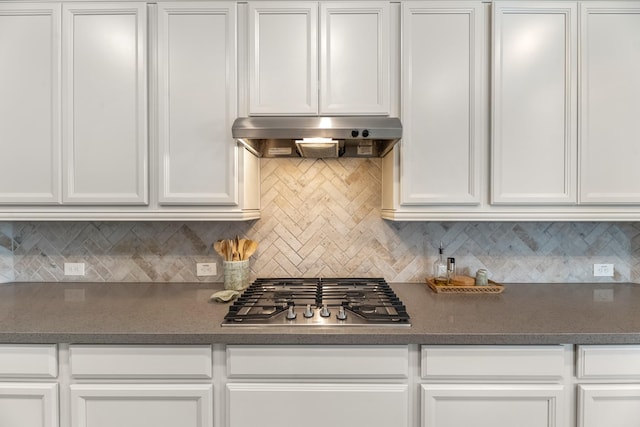15519 Ponderosa Bend Dr, Cypress, TX 77429 - kitchen with stainless steel gas cooktop, range hood, white cabinetry, decorative backsplash, and dark countertops