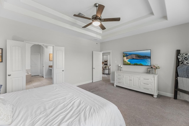 15519 Ponderosa Bend Dr, Cypress, TX 77429 - bedroom with a tray ceiling, light carpet, and a ceiling fan