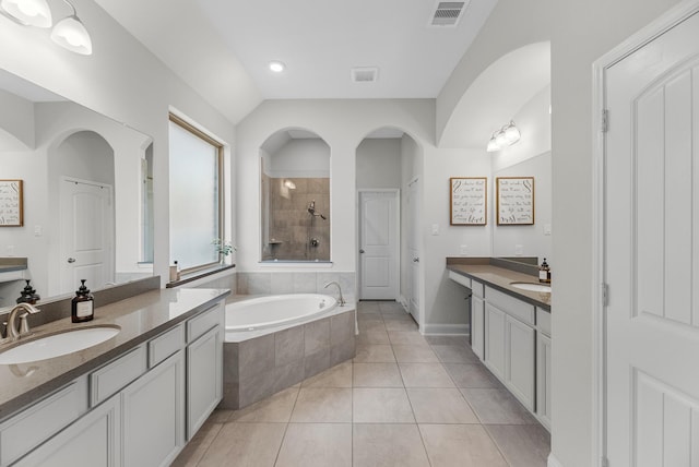 15519 Ponderosa Bend Dr, Cypress, TX 77429 - bathroom with two vanities, a tile shower, tile patterned floors, a bath, and recessed lighting