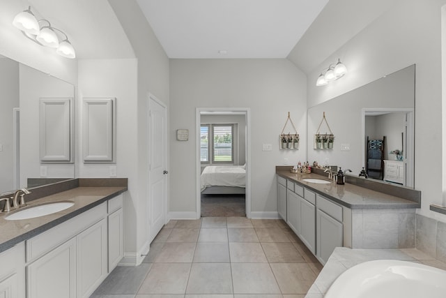 15519 Ponderosa Bend Dr, Cypress, TX 77429 - full bathroom featuring ensuite bathroom, two vanities, tile patterned flooring, a bathtub, and vaulted ceiling