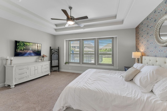 15519 Ponderosa Bend Dr, Cypress, TX 77429 - bedroom featuring a raised ceiling, light colored carpet, a ceiling fan, and wallpapered walls