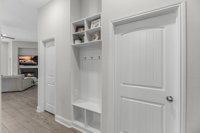15519 Ponderosa Bend Dr, Cypress, TX 77429 - mudroom with wood finished floors and a warm lit fireplace