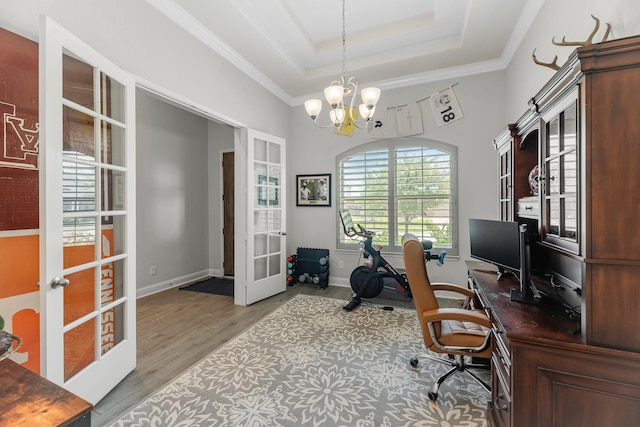 15519 Ponderosa Bend Dr, Cypress, TX 77429 - office area featuring french doors, a chandelier, wood finished floors, a tray ceiling, and crown molding