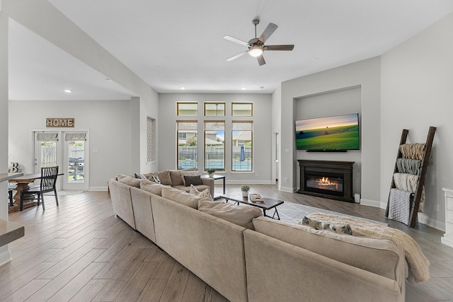 15519 Ponderosa Bend Dr, Cypress, TX 77429 - living room featuring a glass covered fireplace, ceiling fan, wood finished floors, and recessed lighting