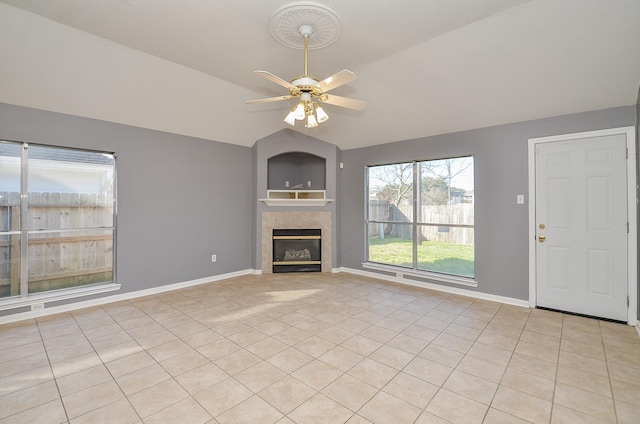 8747 Cypressbrook Dr, Houston, TX 77095 - unfurnished living room featuring ceiling fan, light tile patterned floors, lofted ceiling, and a tile fireplace