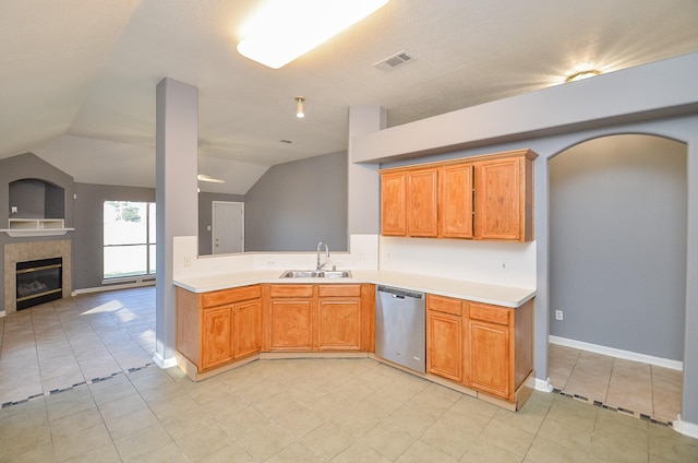 8747 Cypressbrook Dr, Houston, TX 77095 - kitchen with dishwasher, light countertops, lofted ceiling, light tile patterned floors, and a fireplace
