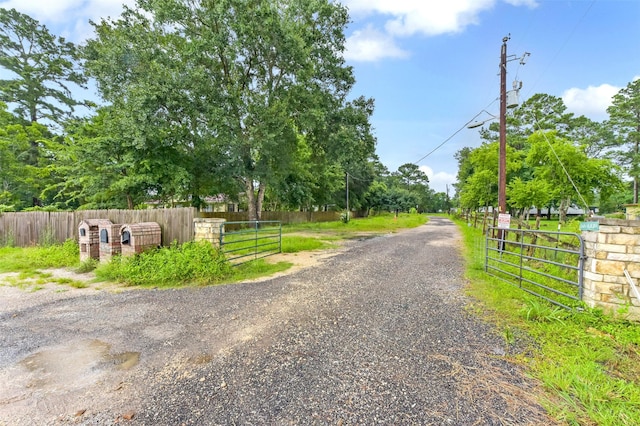 19757 Dorris Dr, Magnolia, TX 77355 - view of dirt / gravel road with a gated entry and a gate