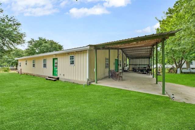 19757 Dorris Dr, Magnolia, TX 77355 - back of property featuring a lawn, board and batten siding, entry steps, a patio, and a metal roof