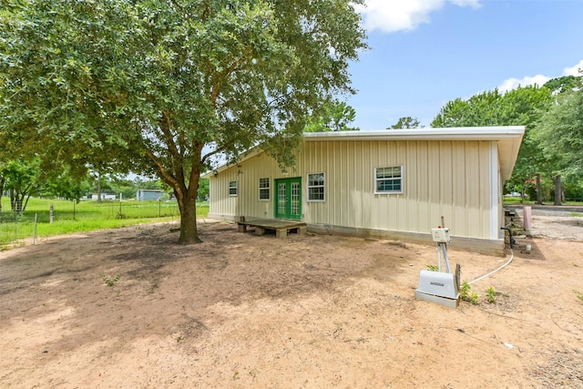 19757 Dorris Dr, Magnolia, TX 77355 - view of side of property with french doors and board and batten siding