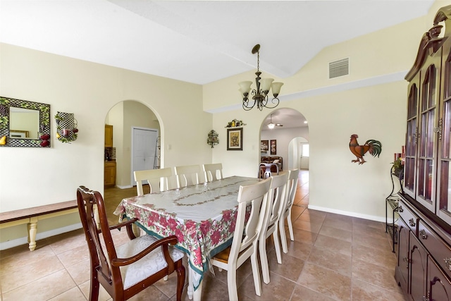 19757 Dorris Dr, Magnolia, TX 77355 - dining room featuring arched walkways, a chandelier, tile patterned flooring, and lofted ceiling