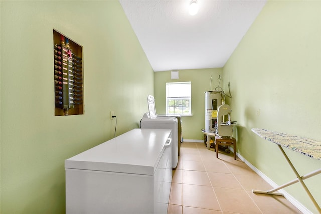 19757 Dorris Dr, Magnolia, TX 77355 - washroom featuring washer and clothes dryer, water heater, and light tile patterned floors