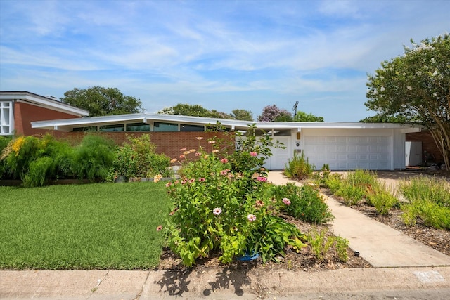 1306 Harbor Vw, Galveston, TX 77551 - mid-century modern home featuring an attached garage, concrete driveway, and a front lawn