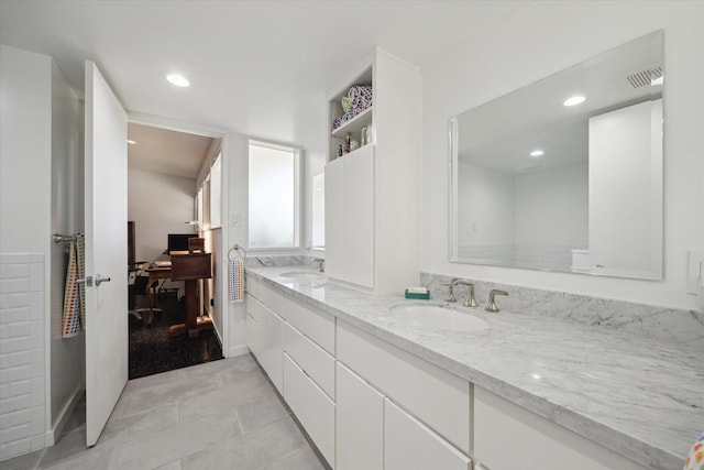 1306 Harbor Vw, Galveston, TX 77551 - bathroom featuring double vanity, tile patterned flooring, and recessed lighting