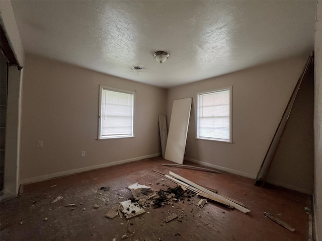 703 W Sterling St, Baytown, TX 77520 - empty room with plenty of natural light and a textured ceiling