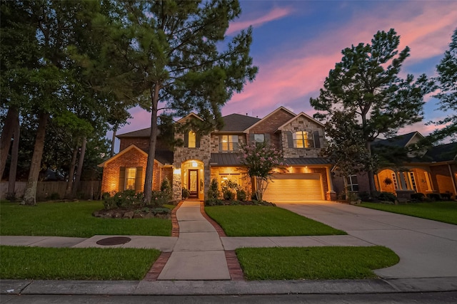 18315 Cape Lookout Way, Humble, TX 77346 - traditional home with concrete driveway, an attached garage, stone siding, a standing seam roof, and brick siding