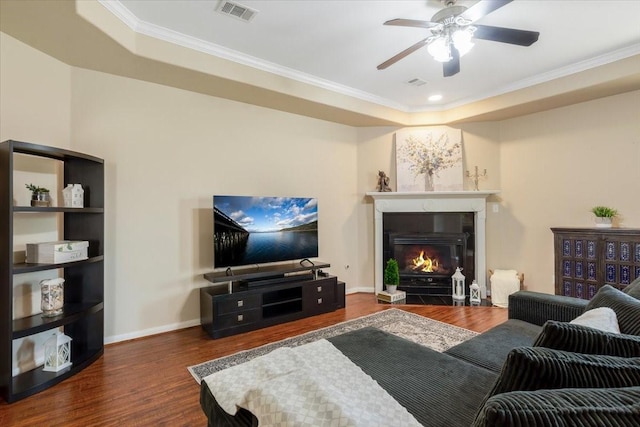 5343 Oak Cove Dr, Houston, TX 77091 - living area with a tray ceiling, wood finished floors, a ceiling fan, crown molding, and a fireplace with flush hearth