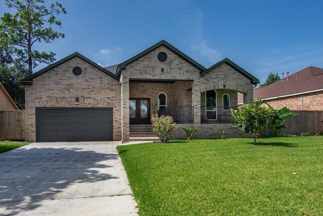 5343 Oak Cove Dr, Houston, TX 77091 - french country inspired facade featuring brick siding, driveway, a garage, and french doors