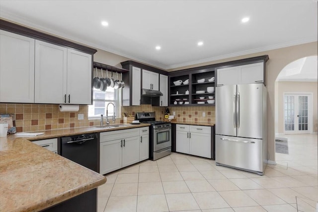 5343 Oak Cove Dr, Houston, TX 77091 - kitchen featuring stainless steel appliances, arched walkways, under cabinet range hood, crown molding, and open shelves