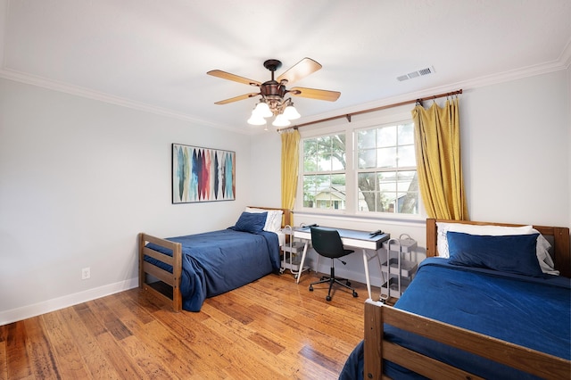2120 Gostick St, Houston, TX 77008 - bedroom with ornamental molding, light wood-style flooring, a ceiling fan, and a desk