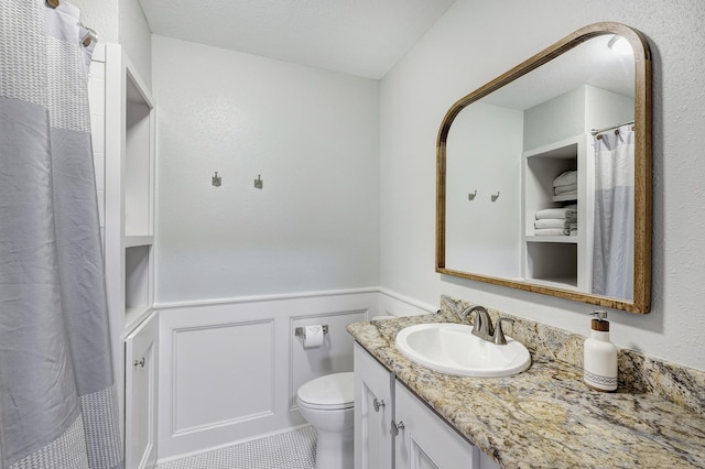 2120 Gostick St, Houston, TX 77008 - bathroom with vanity, wainscoting, and a decorative wall