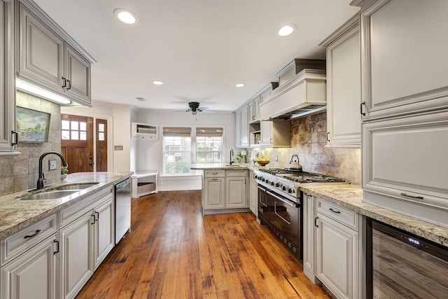 2120 Gostick St, Houston, TX 77008 - kitchen featuring stainless steel appliances, wine cooler, backsplash, premium range hood, and recessed lighting