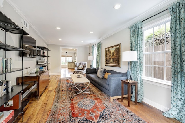 2120 Gostick St, Houston, TX 77008 - living room with light wood finished floors, crown molding, and recessed lighting