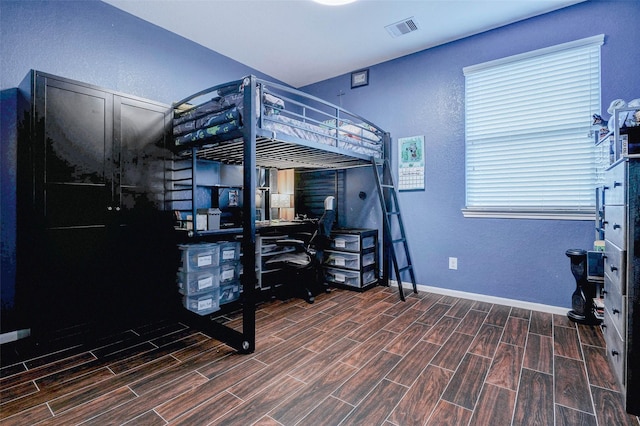 2302 Lakecrest Gardens Dr, Katy, TX 77493 - bedroom featuring wood finished floors, a textured wall, and an office area