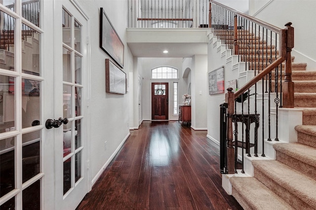 2302 Lakecrest Gardens Dr, Katy, TX 77493 - foyer entrance with wood-type flooring, stairs, arched walkways, a towering ceiling, and french doors