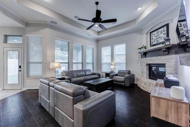 2302 Lakecrest Gardens Dr, Katy, TX 77493 - living area featuring a tray ceiling, ceiling fan, a fireplace, hardwood / wood-style flooring, and ornamental molding