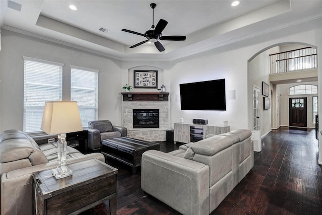 2302 Lakecrest Gardens Dr, Katy, TX 77493 - living room featuring a tray ceiling, arched walkways, recessed lighting, a ceiling fan, and dark wood-style flooring
