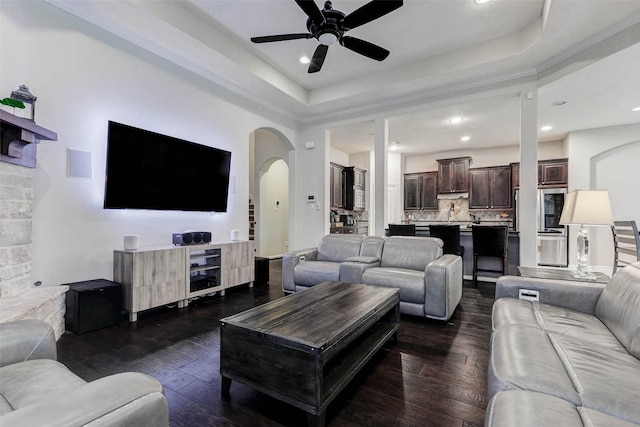 2302 Lakecrest Gardens Dr, Katy, TX 77493 - living area featuring arched walkways, ceiling fan, dark wood-type flooring, a tray ceiling, and recessed lighting