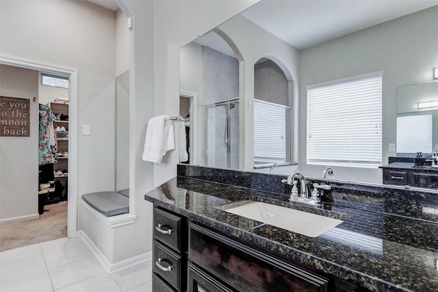 2302 Lakecrest Gardens Dr, Katy, TX 77493 - bathroom featuring a shower stall, a spacious closet, vanity, and tile patterned flooring