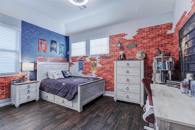 2302 Lakecrest Gardens Dr, Katy, TX 77493 - bedroom with dark wood-style flooring and brick wall
