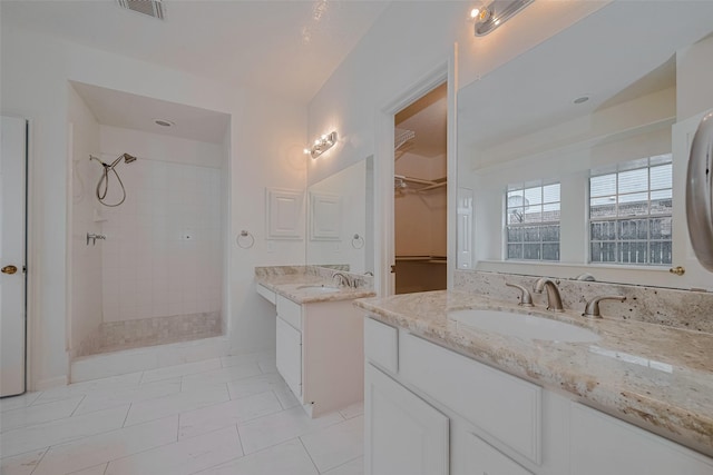 1615 Monvale Ln, Sugar Land, TX 77479 - full bathroom with a tile shower, two vanities, and a walk in closet