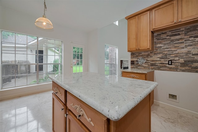 1615 Monvale Ln, Sugar Land, TX 77479 - kitchen featuring tasteful backsplash, hanging light fixtures, light stone countertops, and a center island