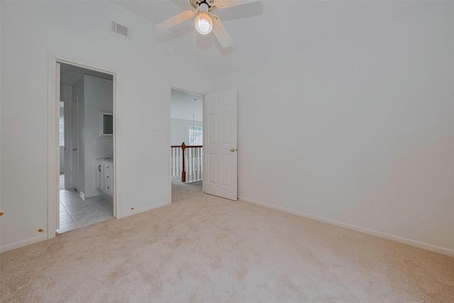 1615 Monvale Ln, Sugar Land, TX 77479 - unfurnished bedroom featuring light carpet, vaulted ceiling, ensuite bathroom, and a ceiling fan